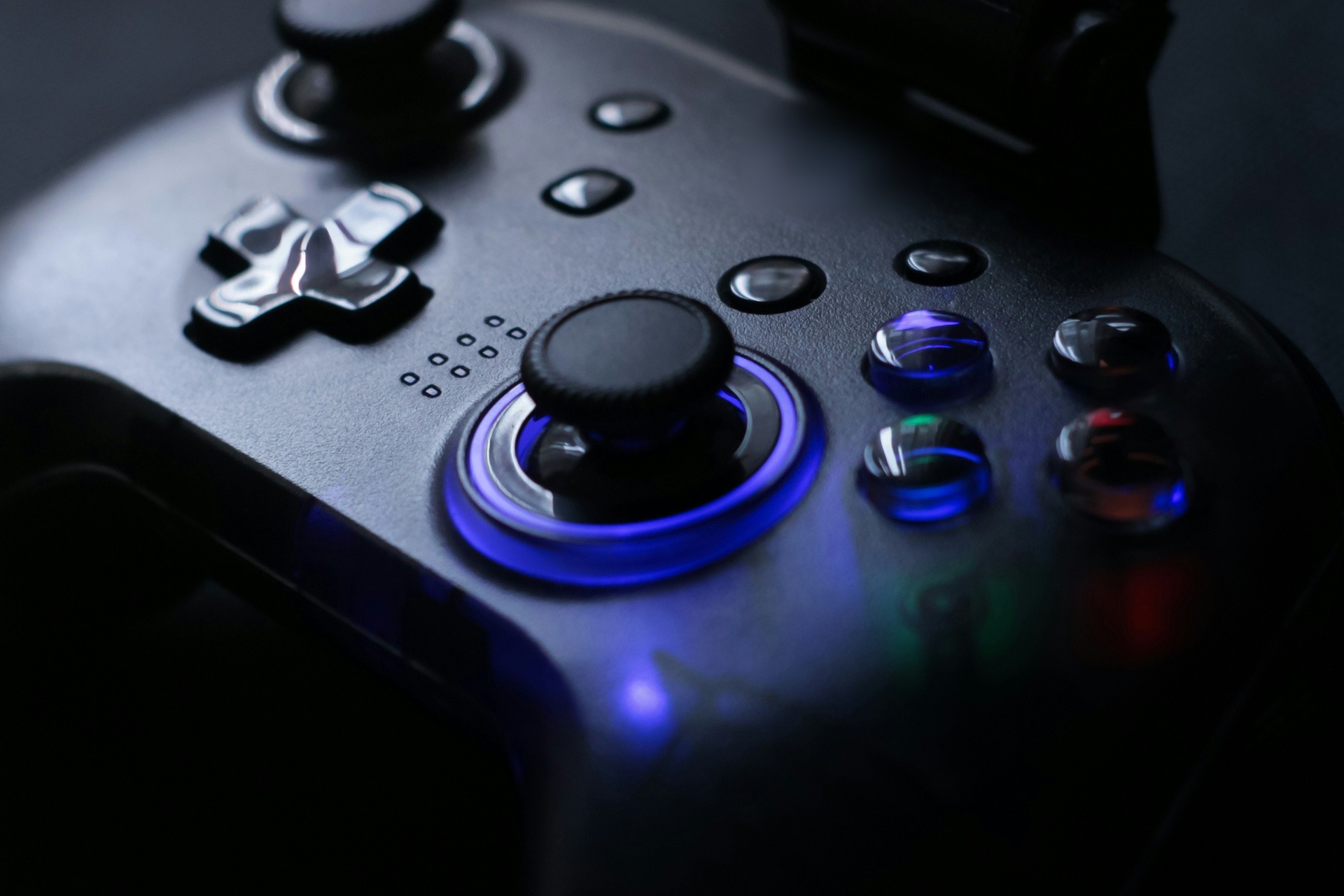 A game controller on a wooden desk